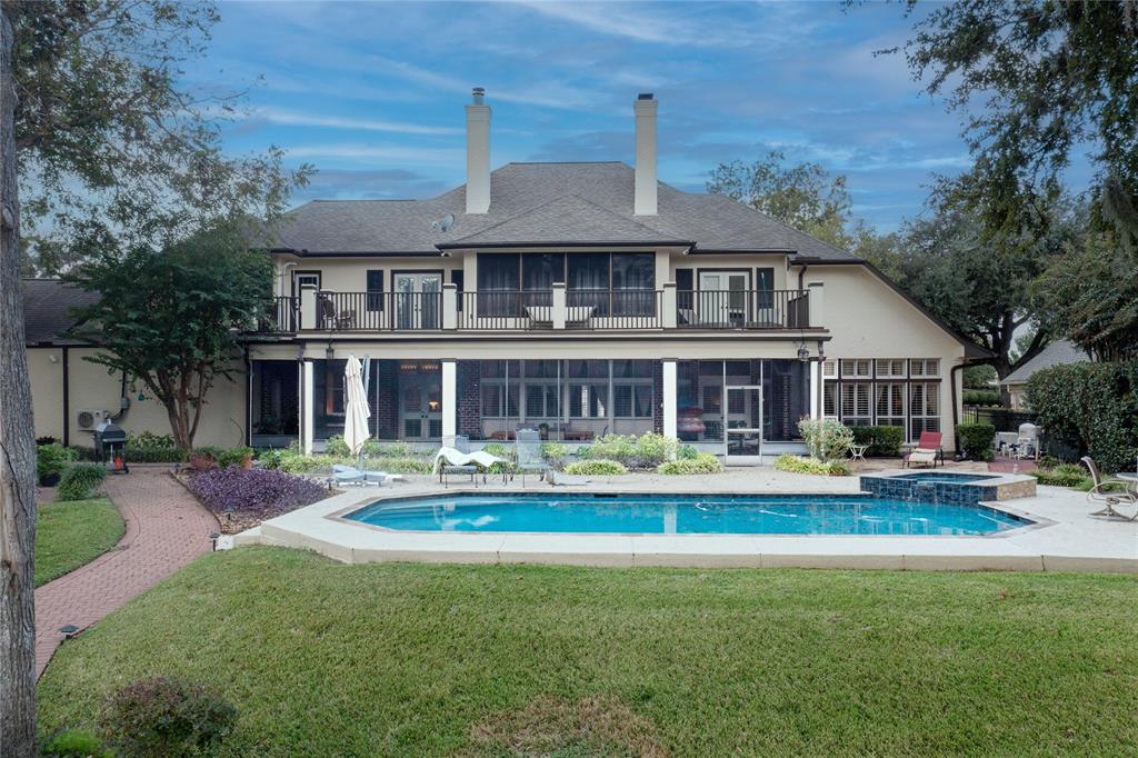 a front view of a house with swimming pool having outdoor seating