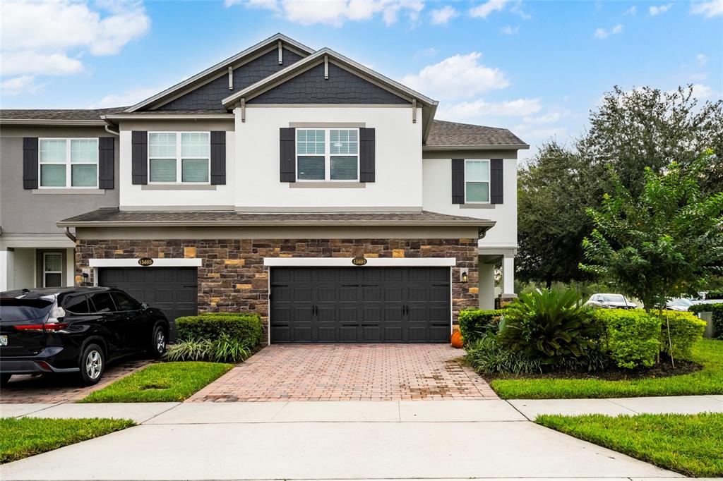 a front view of a house with a yard and garage