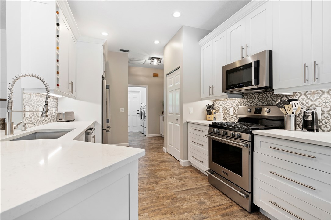 a kitchen with stainless steel appliances a stove microwave and refrigerator