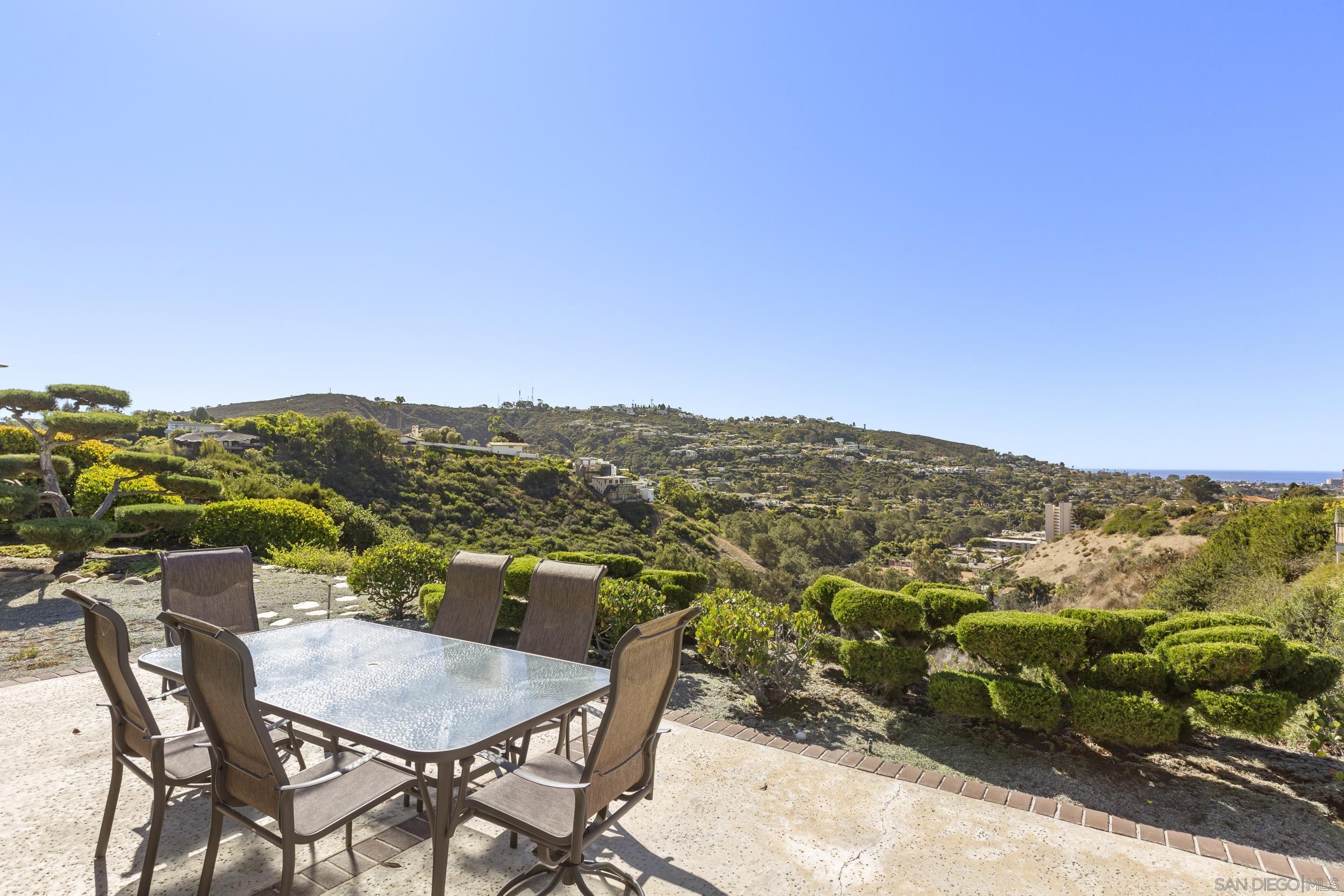 a view of a chairs and table in a terrace