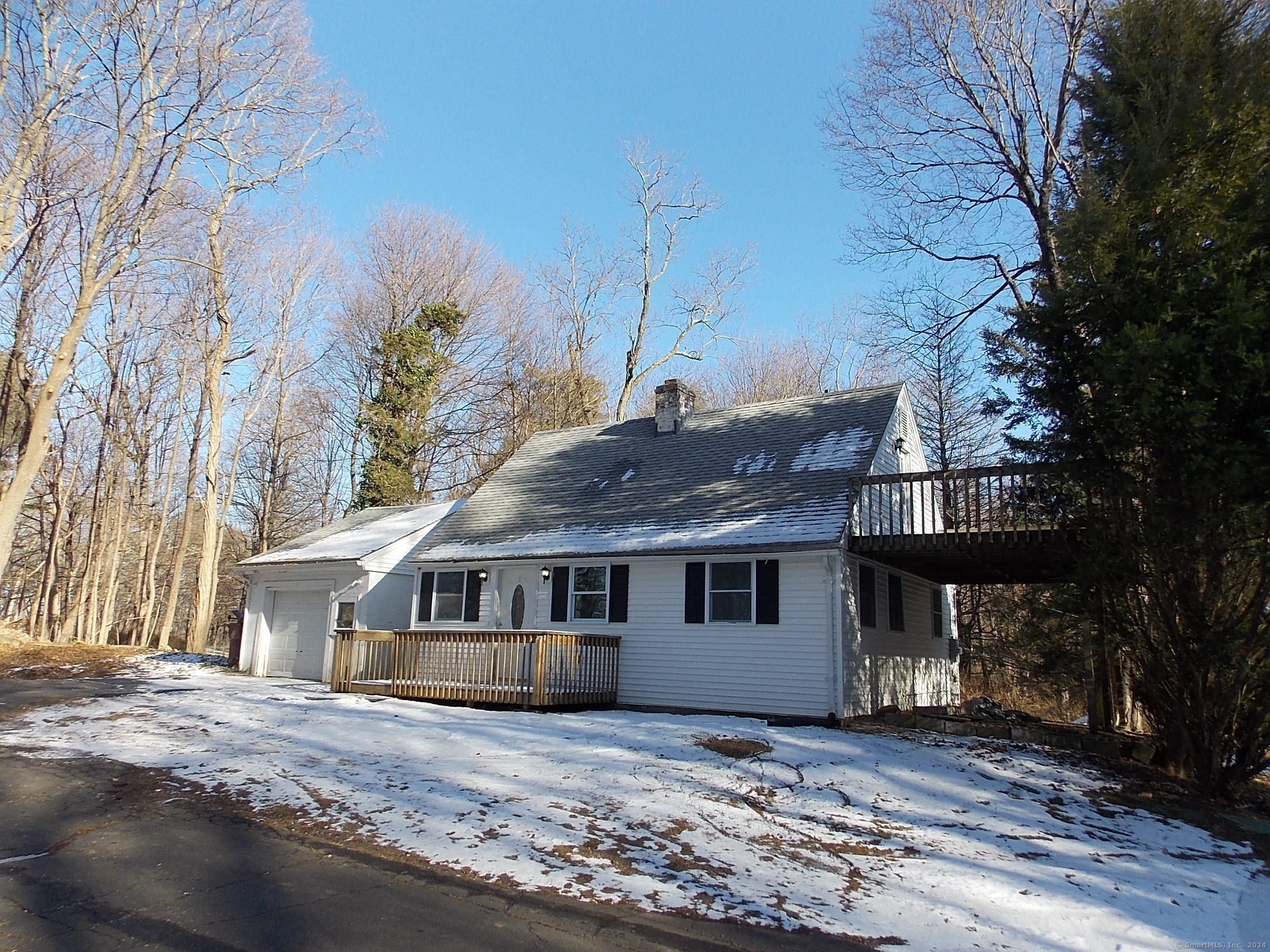 a house that has a big tree in front of it