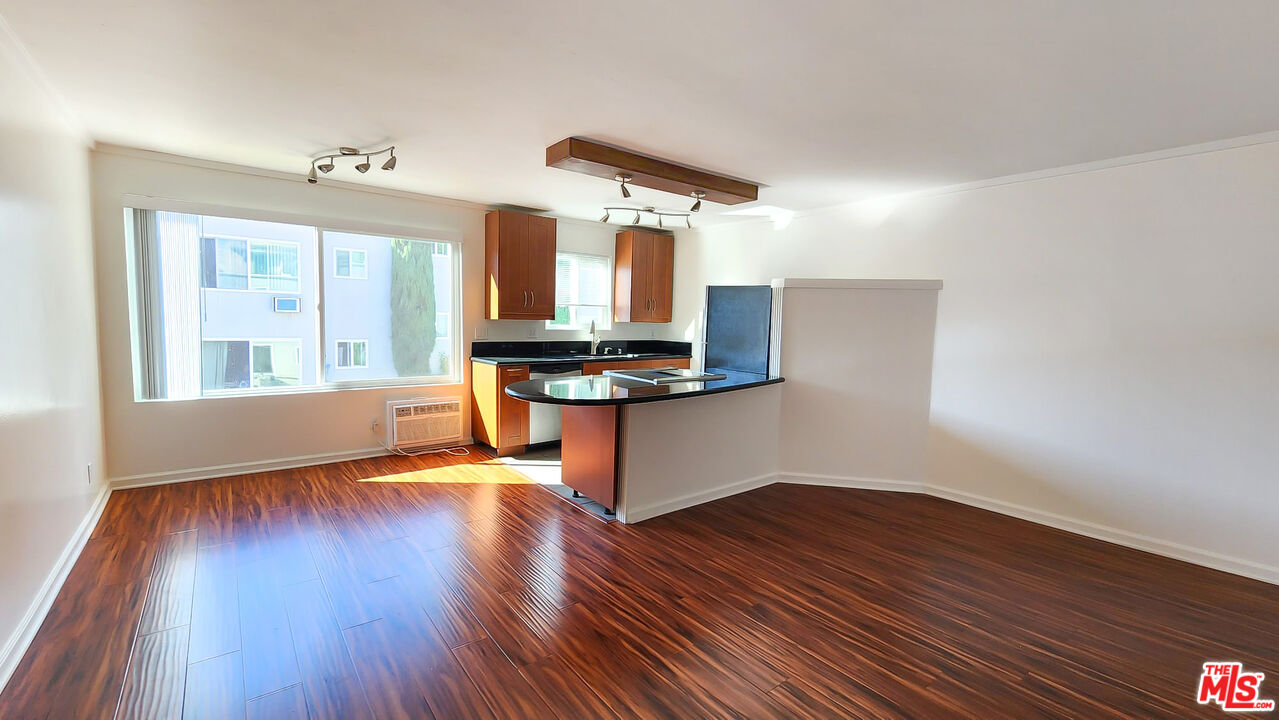 a kitchen with wooden floors and a sink