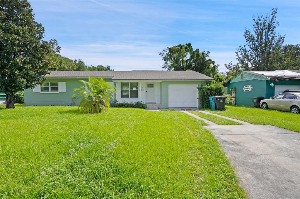 a front view of house with yard and green space