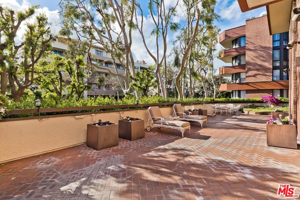 a view of swimming pool with outdoor seating and plants