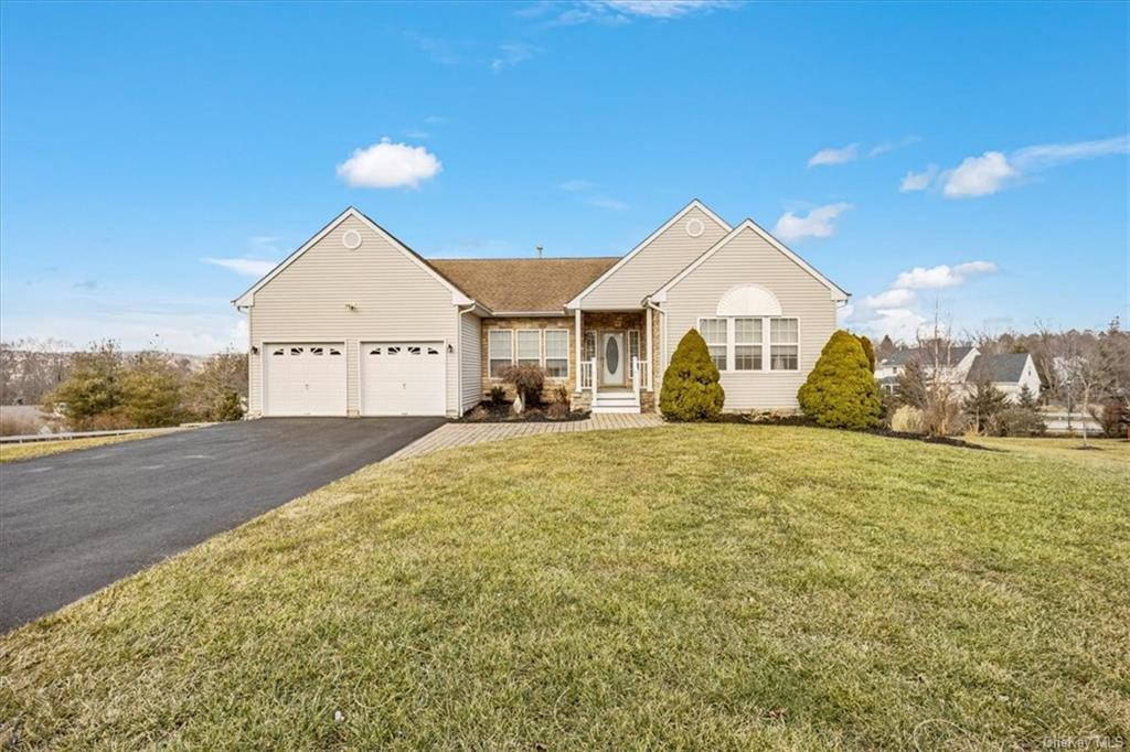 a front view of a house with a yard and garage