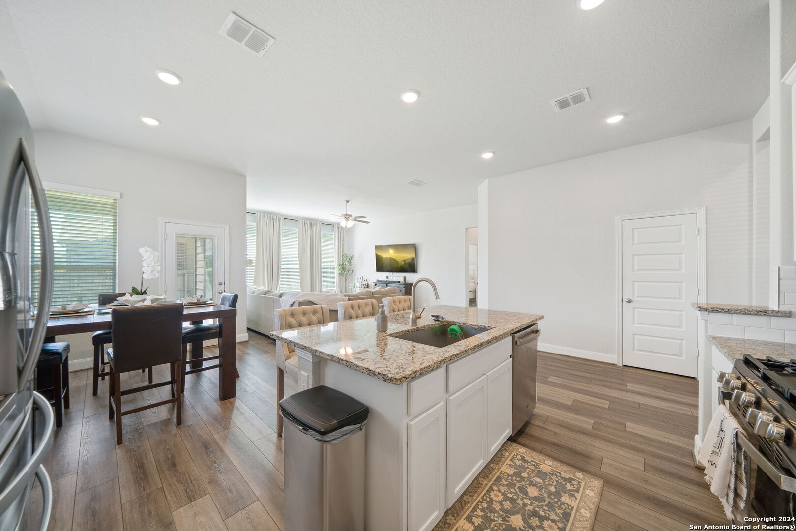 a kitchen with sink stove and dining table