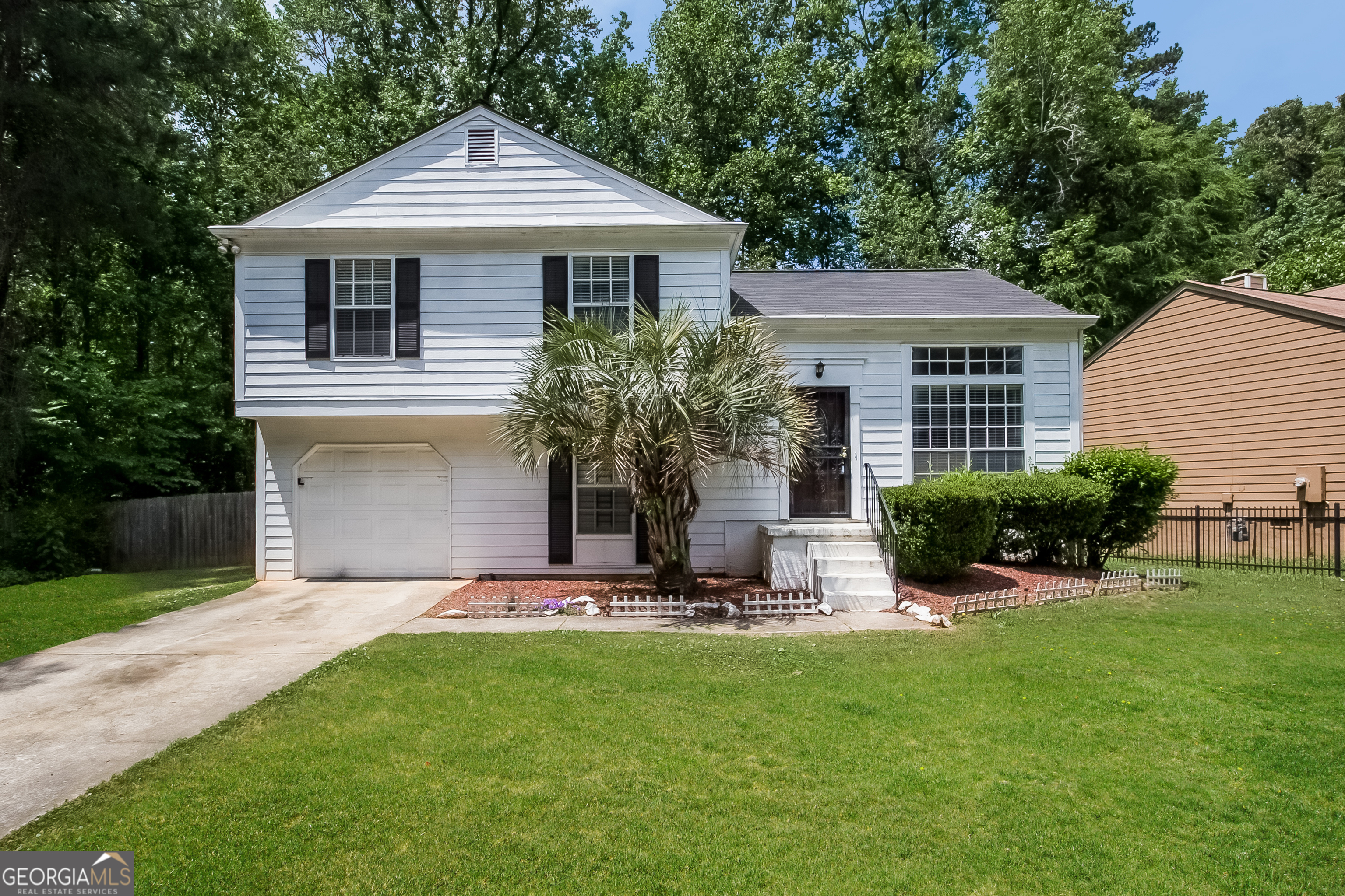 a front view of a house with a yard and porch