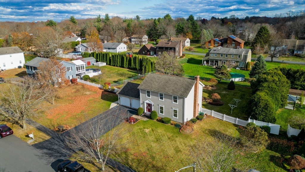 a view of a house with a yard and lake view