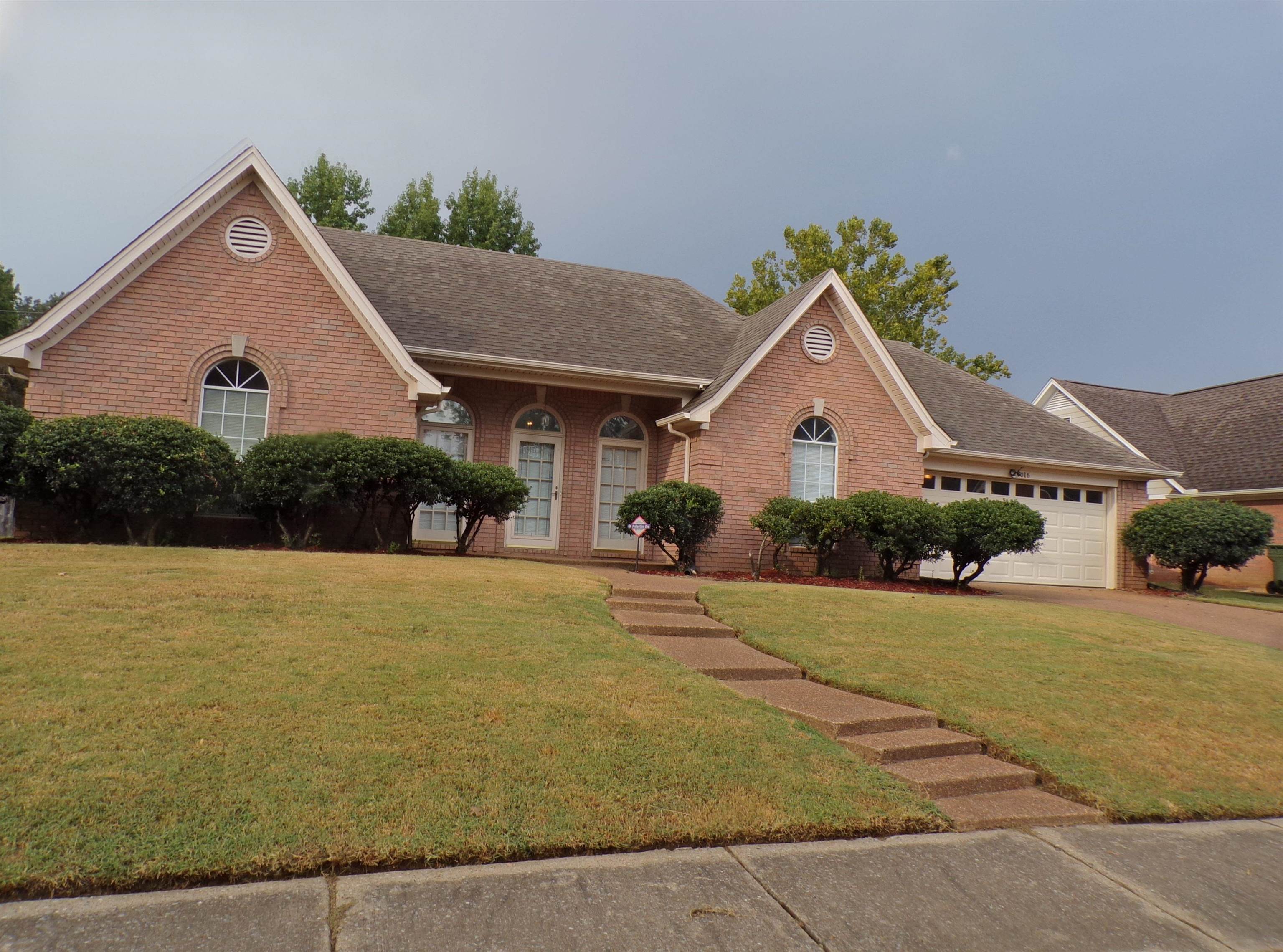 View of front of home featuring a garage and a front lawn