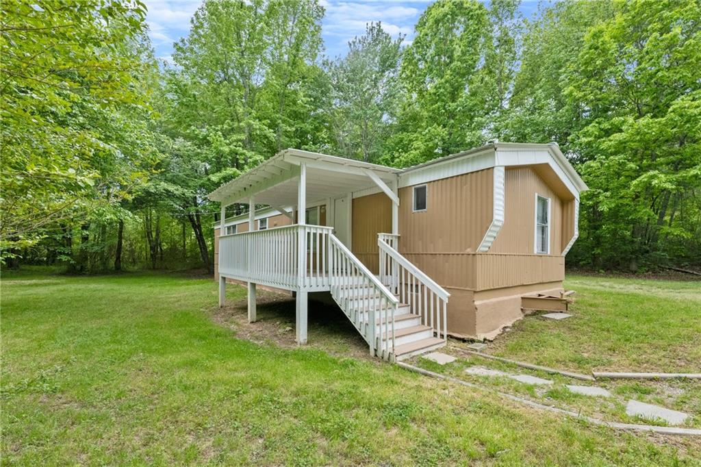 a view of a house with a yard and deck