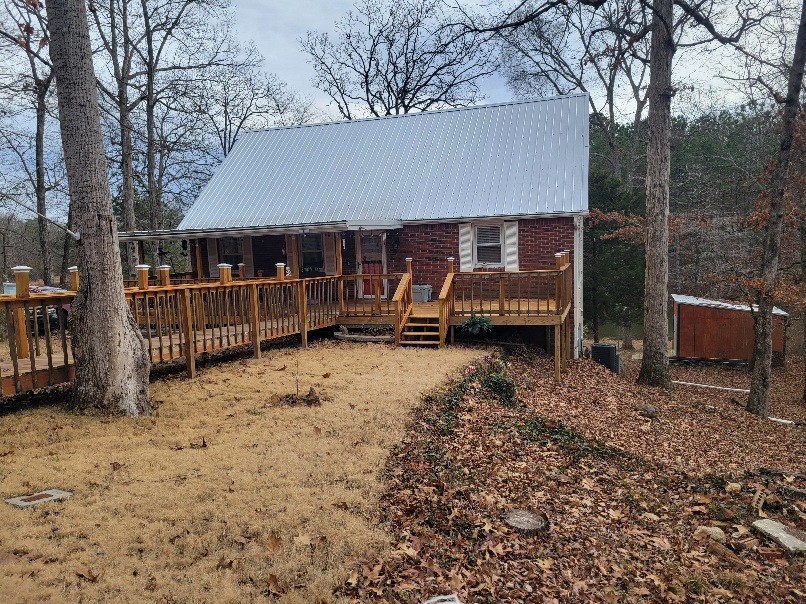 a view of a house with a yard covered in snow