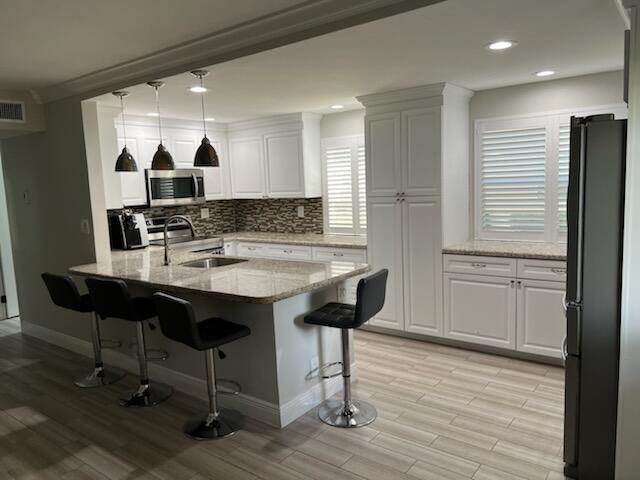 a kitchen with a sink cabinets and wooden floor