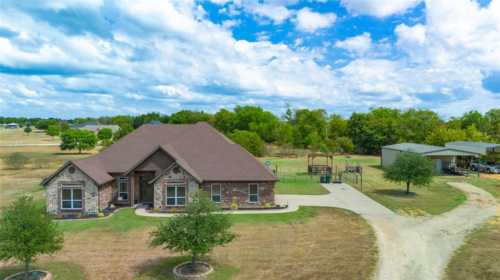 an aerial view of a house with a yard