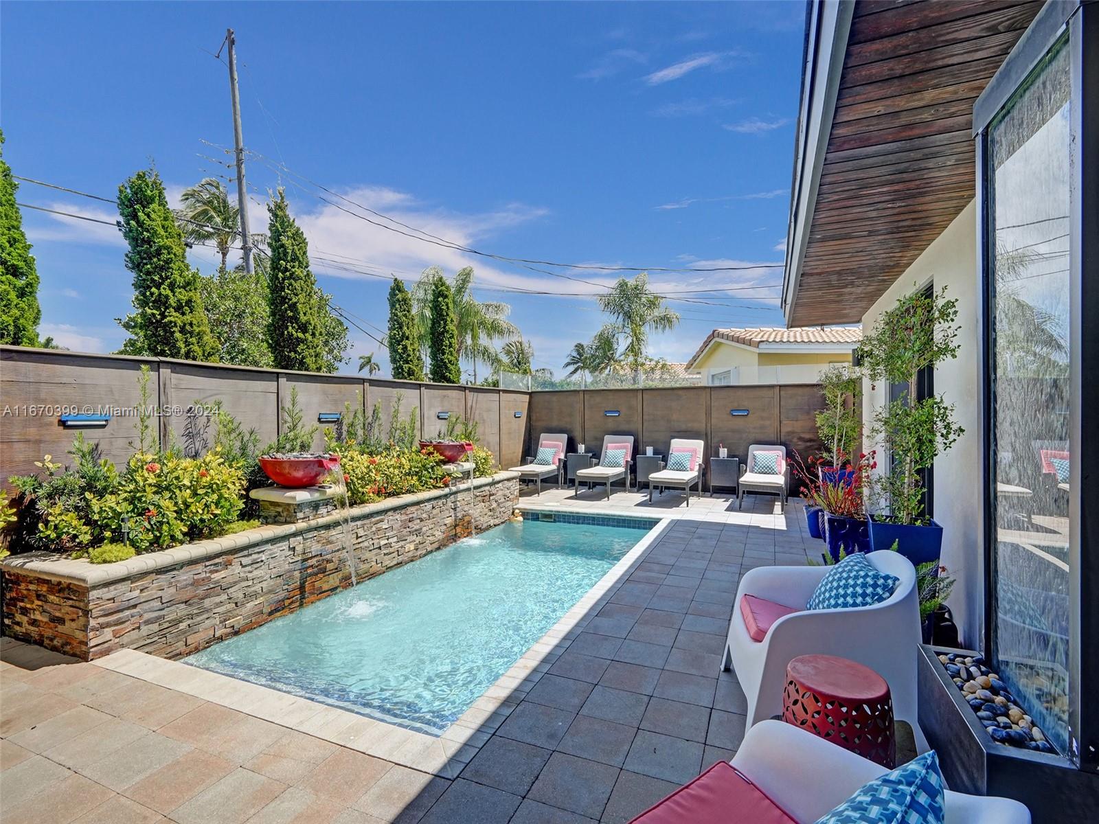 a view of a chairs and tables in the backyard