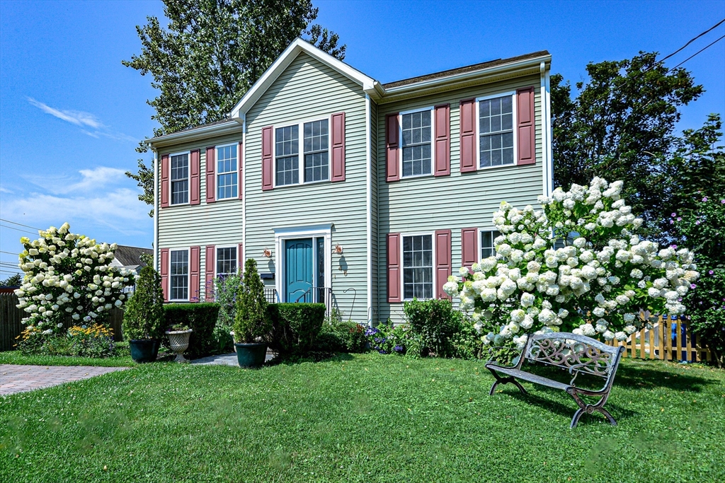 a front view of a house with a garden