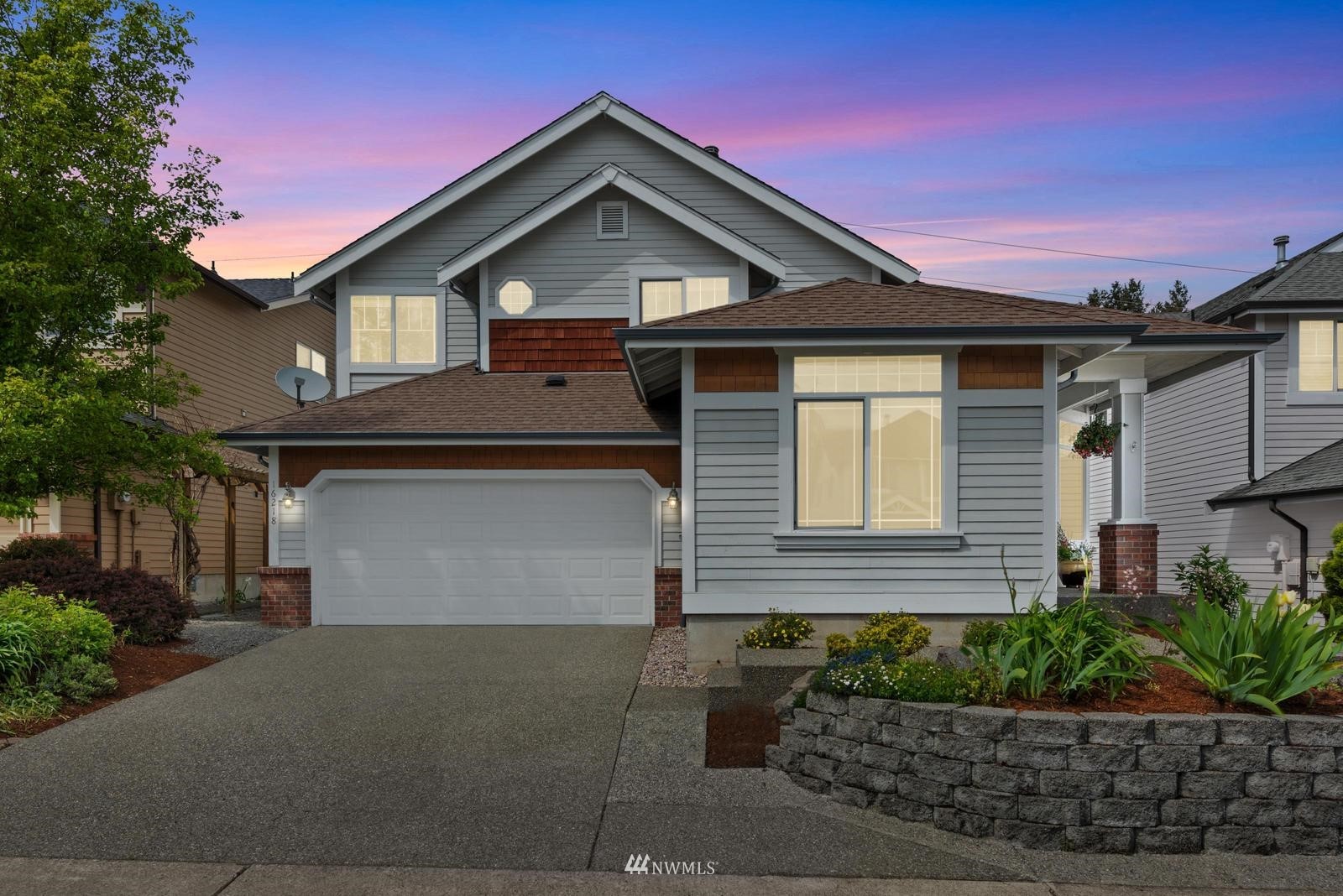 a front view of a house with a yard and garage