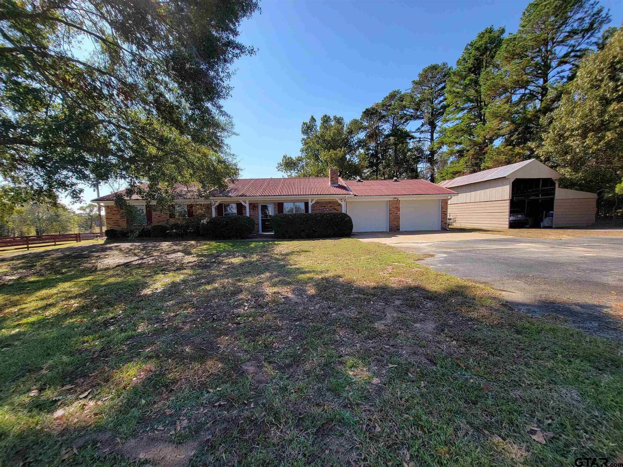 a view of a house with a yard and tree