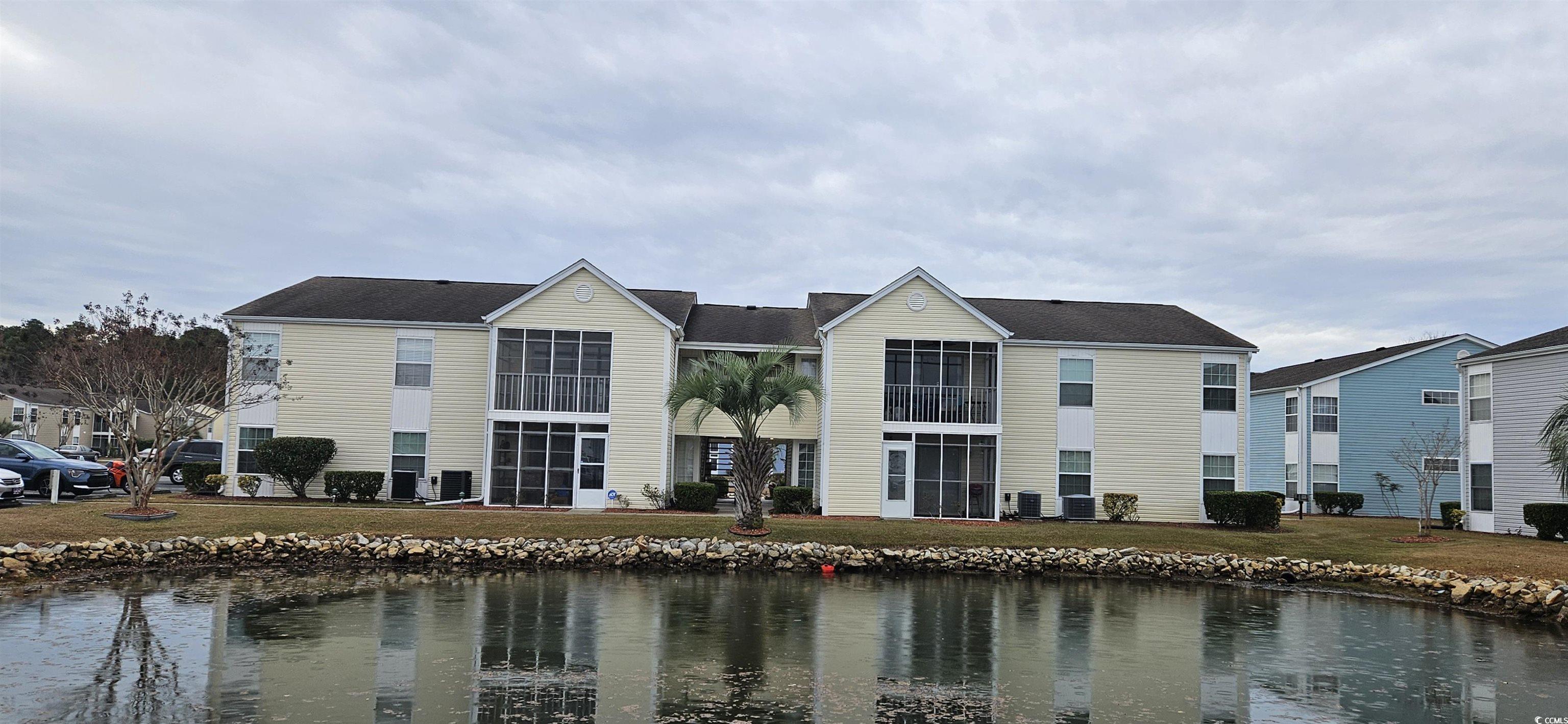 View of property with a water view