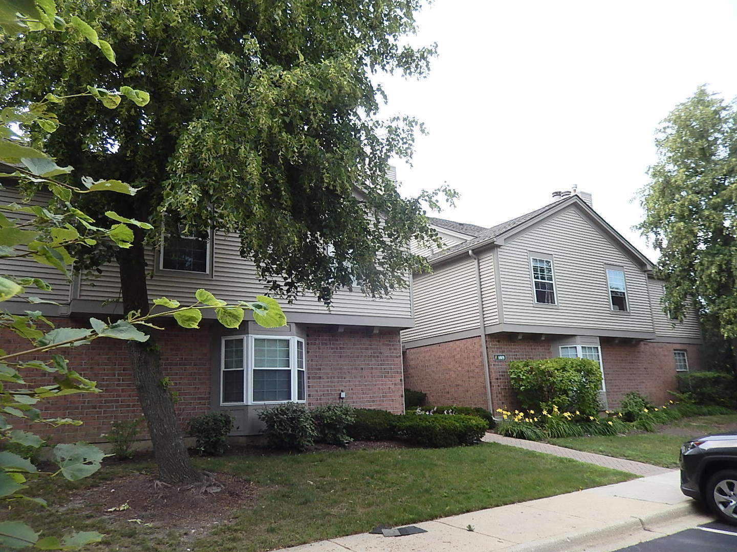 a front view of a house with a garden