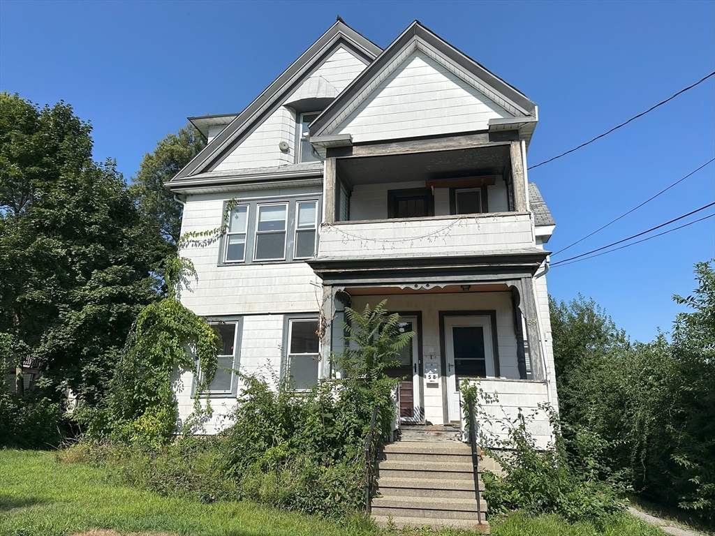 a front view of a house with a yard balcony