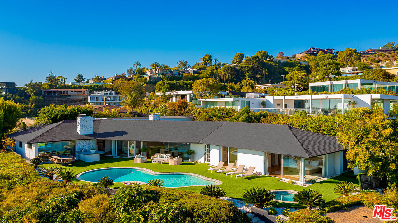 a aerial view of a house with swimming pool garden and lake view