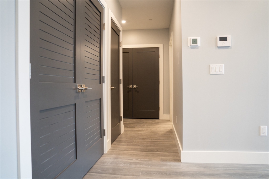 a view of a hallway with wooden floor