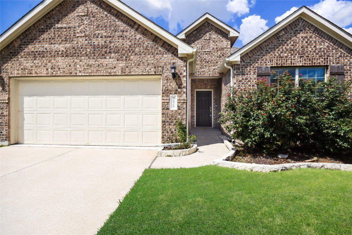 front view of a house with a yard