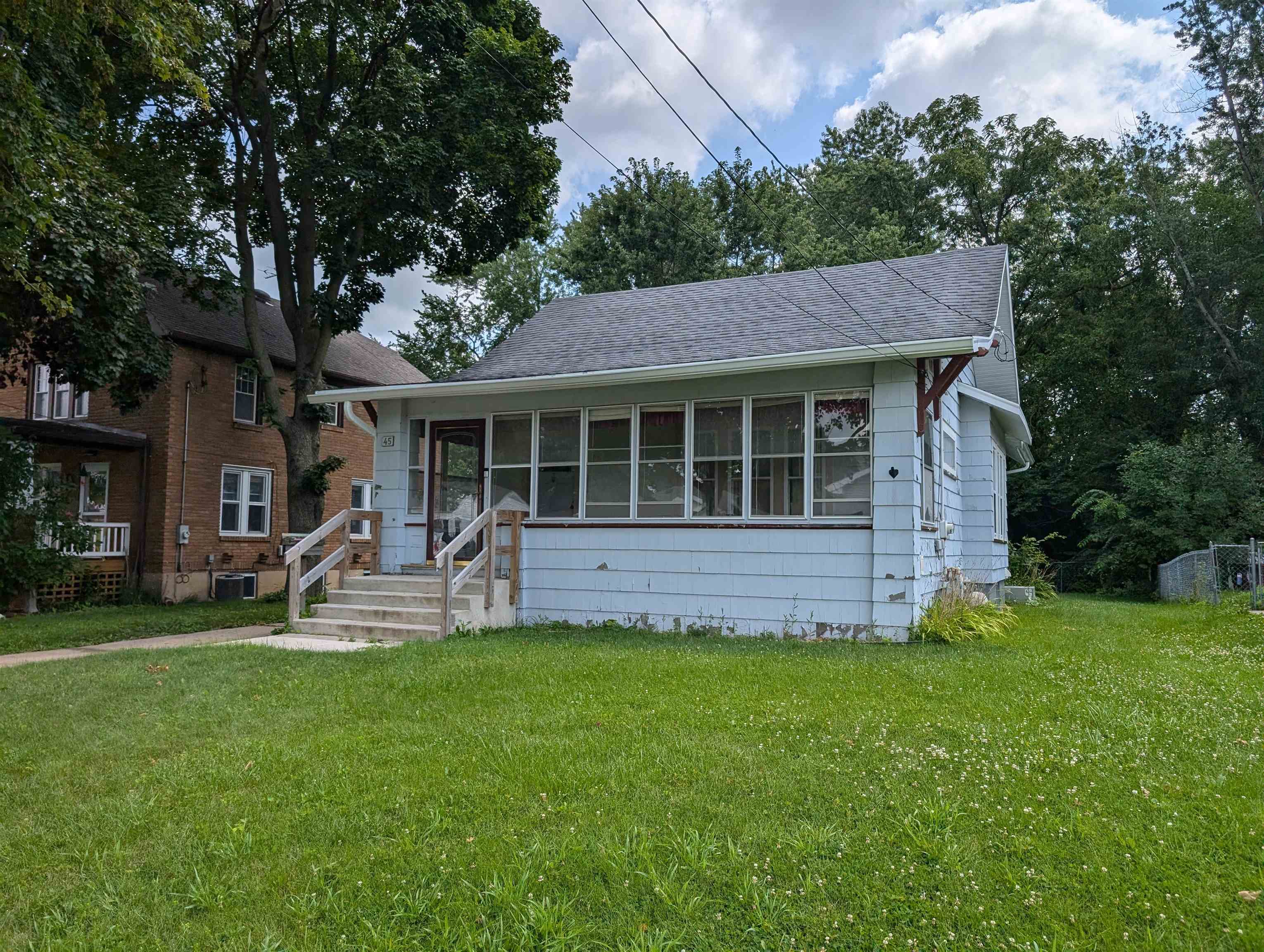 a house view with a sitting space and garden