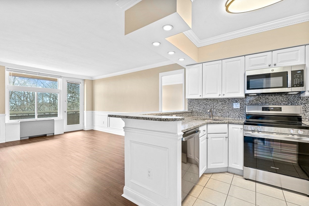 a kitchen with stainless steel appliances granite countertop a stove and a sink