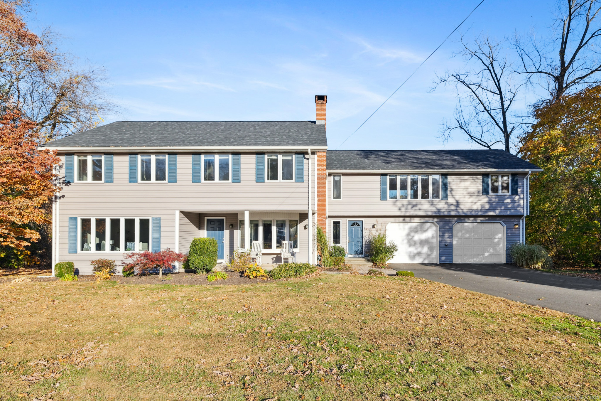 a front view of a residential houses with yard