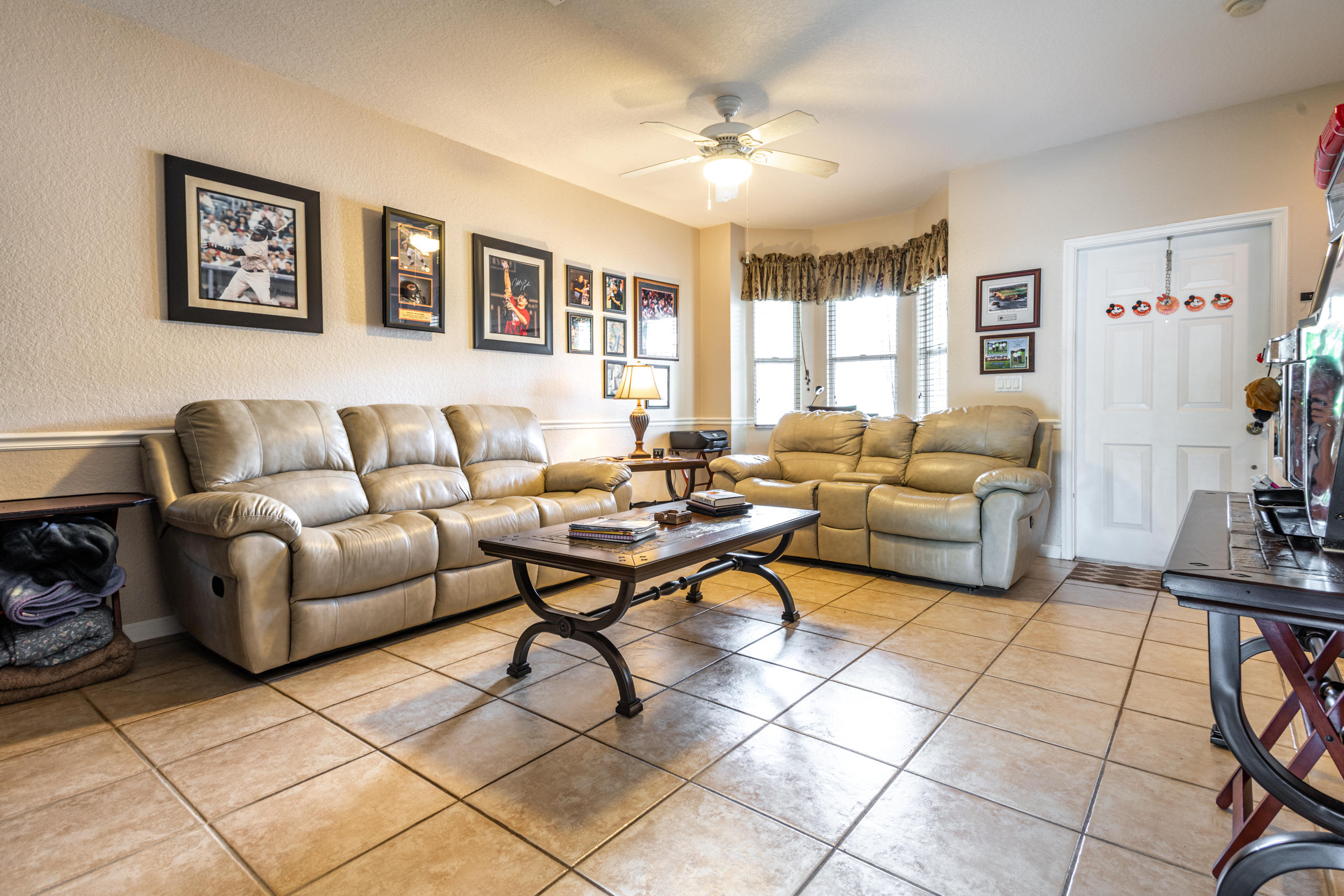 a living room with furniture a dining table and a piano table with wooden floor