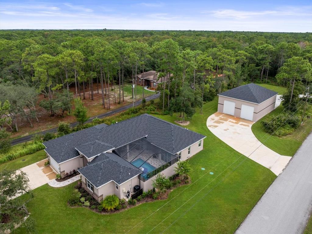 an aerial view of a house with swimming pool garden and outdoor seating