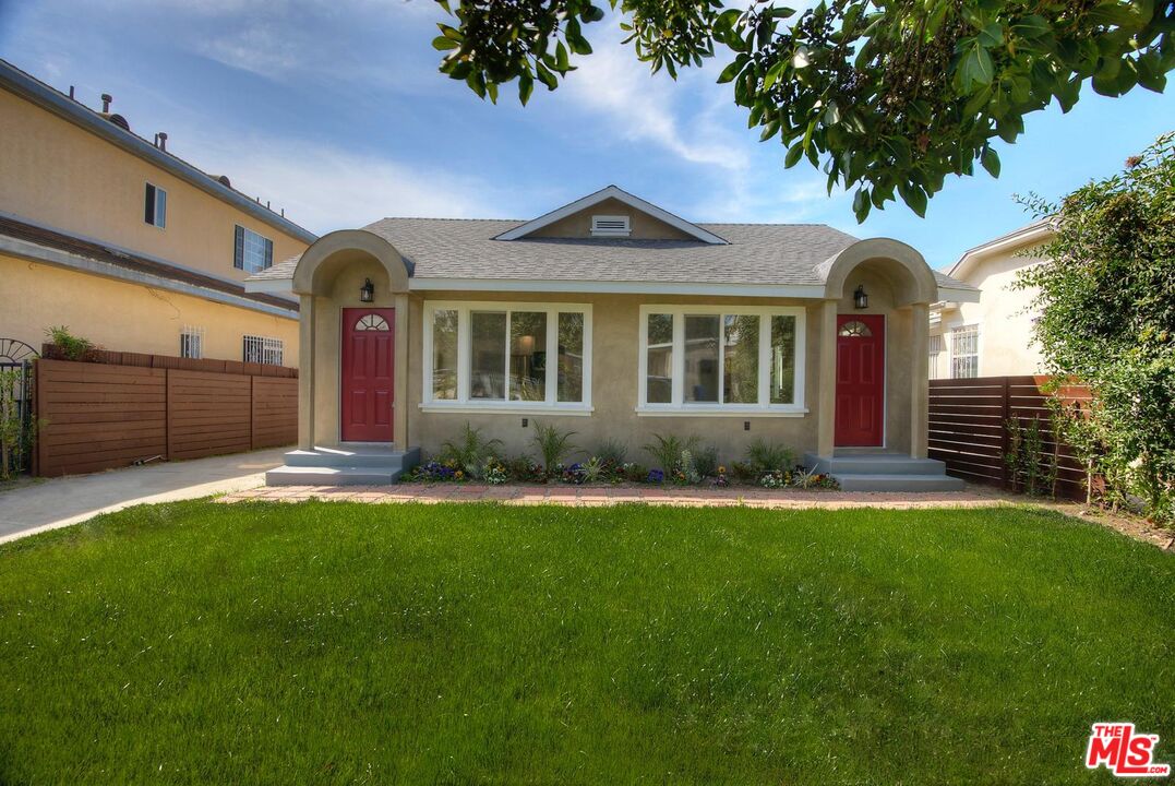 a front view of a house with a garden