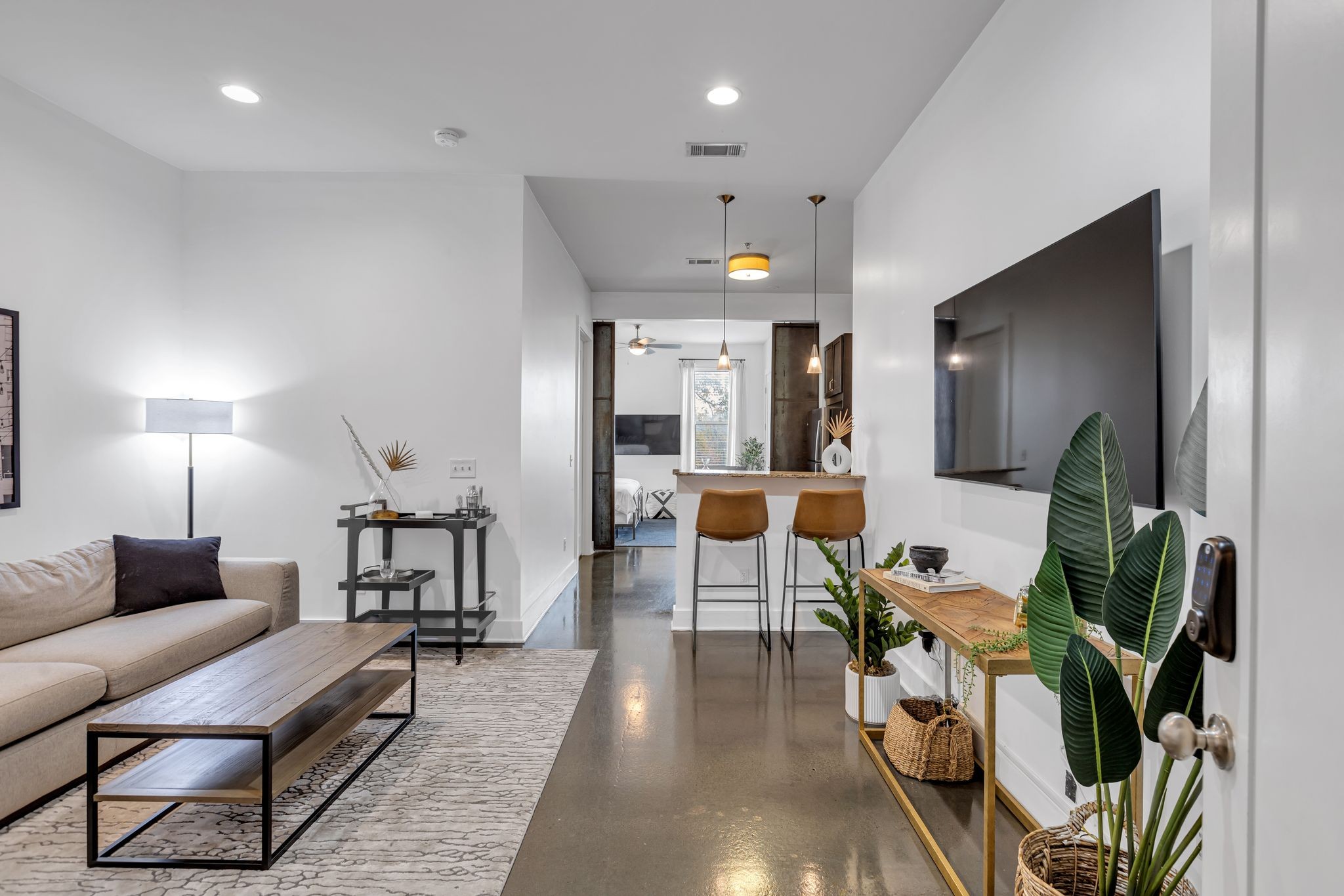 a living room with furniture and wooden floor