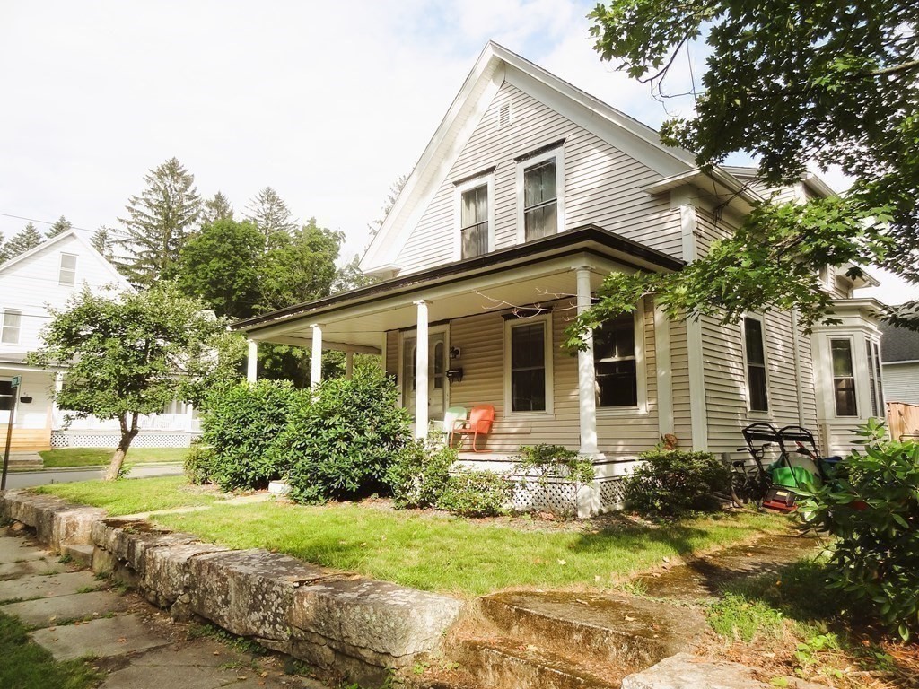 a front view of house with yard and green space