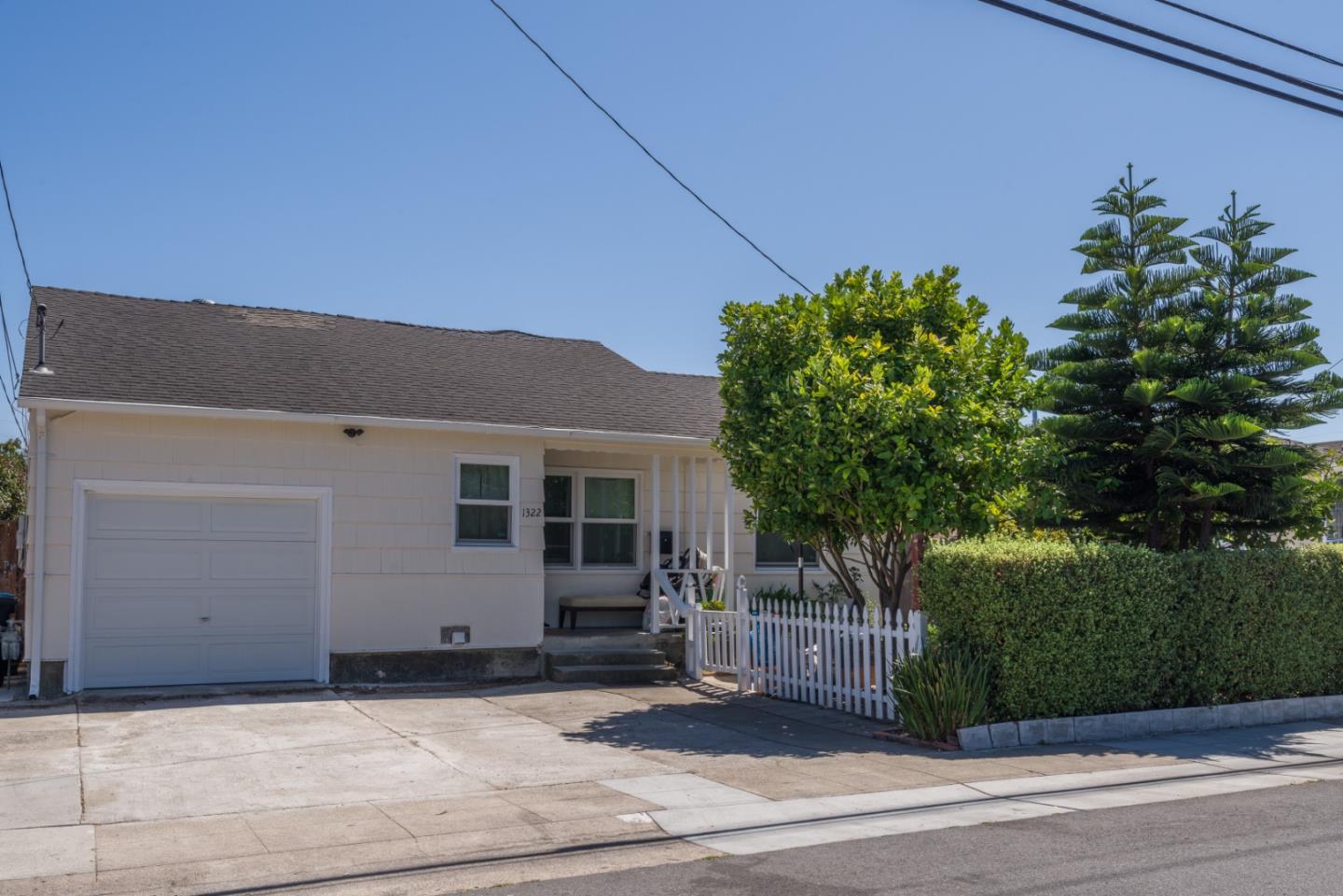 a view of a house with a yard and garage