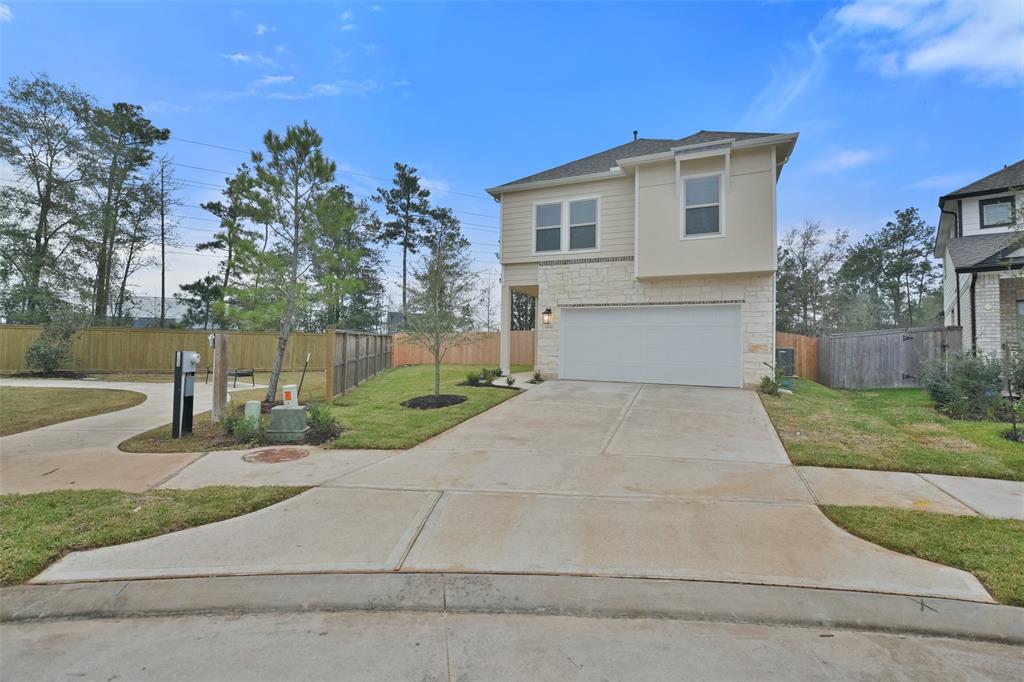 a front view of a house with a yard and a garage