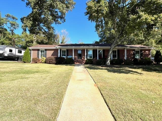 a front view of house with yard and green space