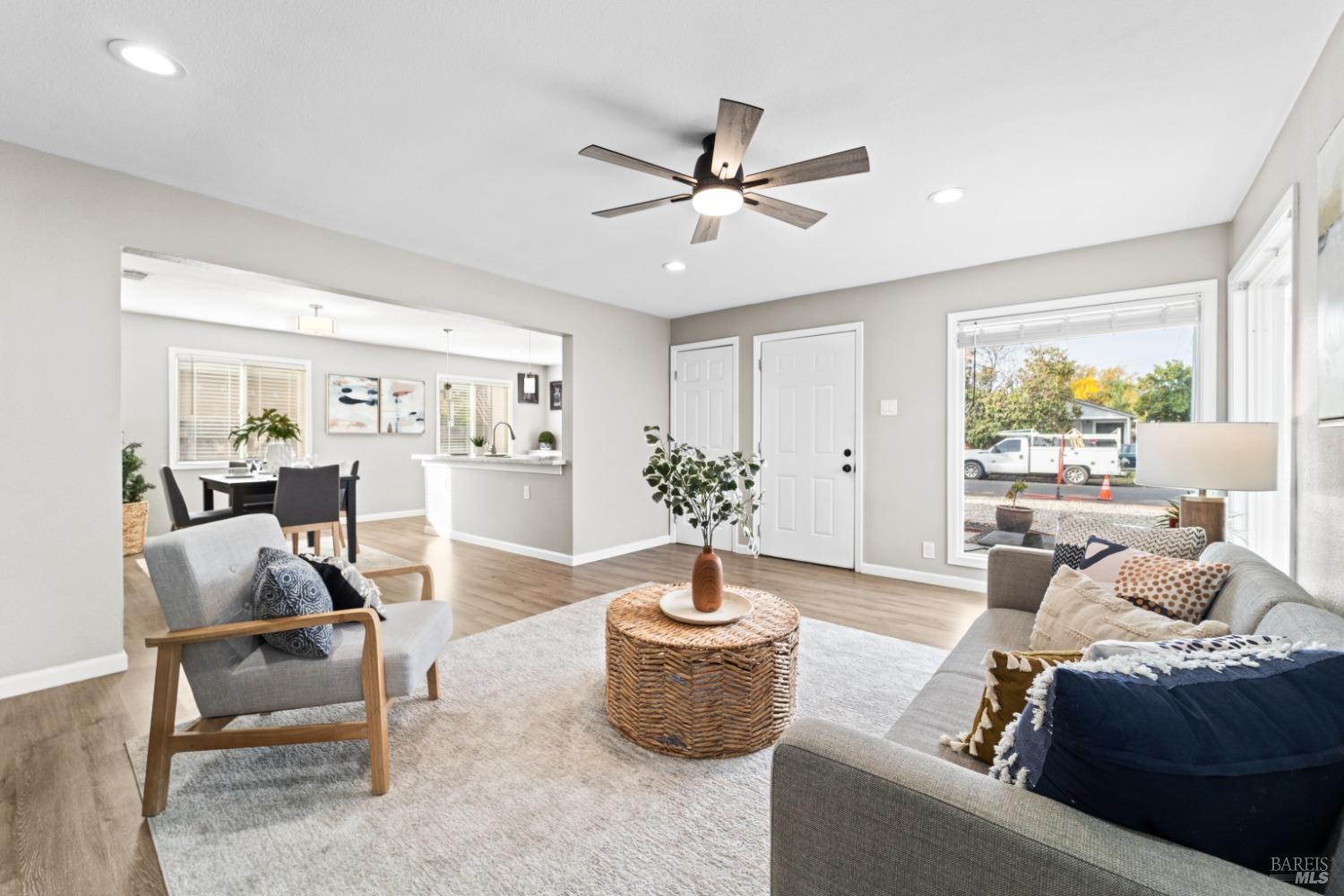 a living room with furniture and a potted plant