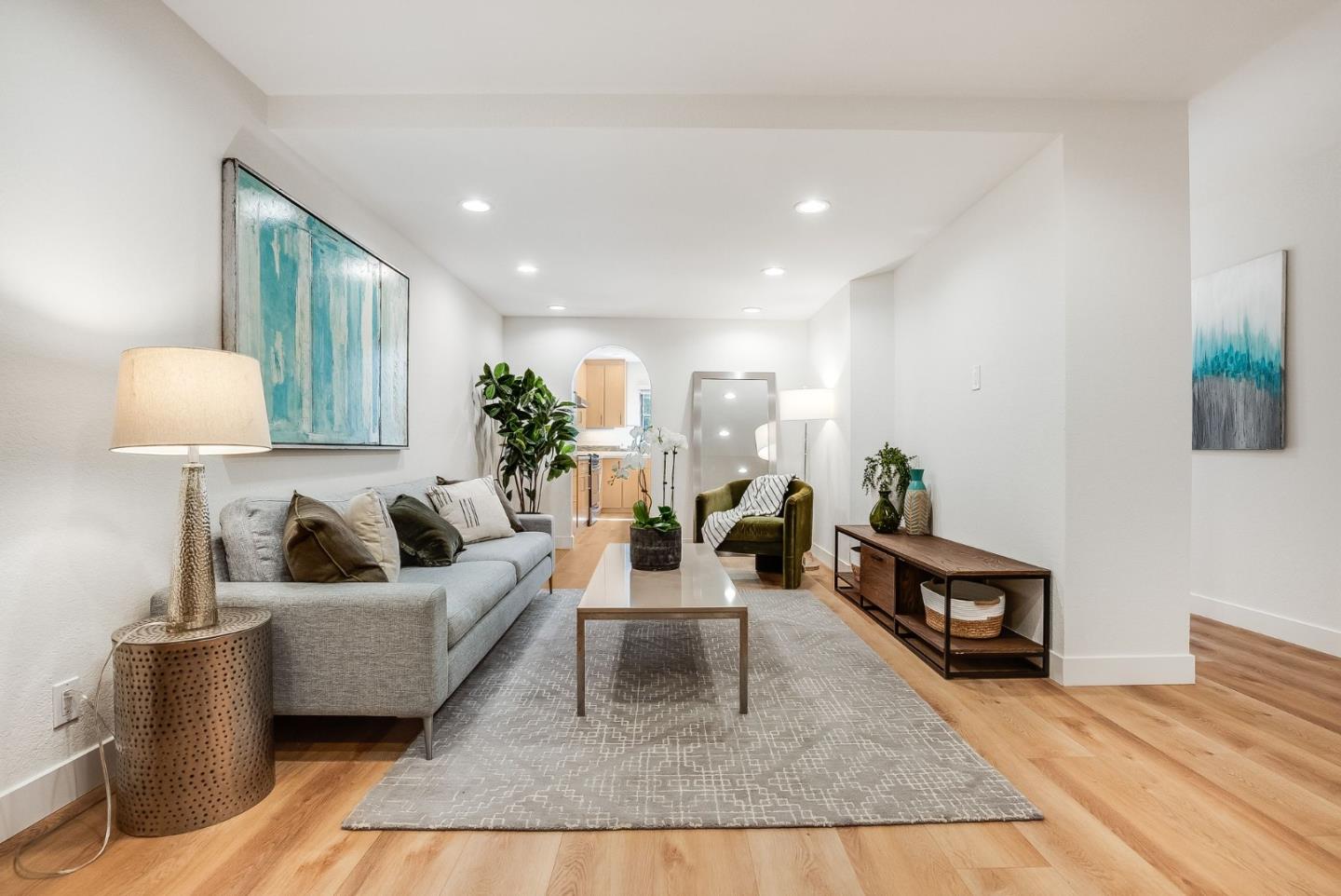 a living room with furniture and a lamp