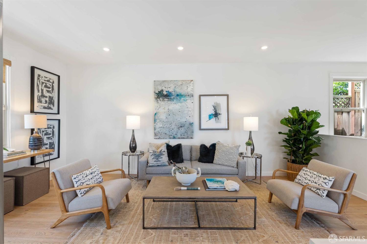 a living room with furniture and a potted plant