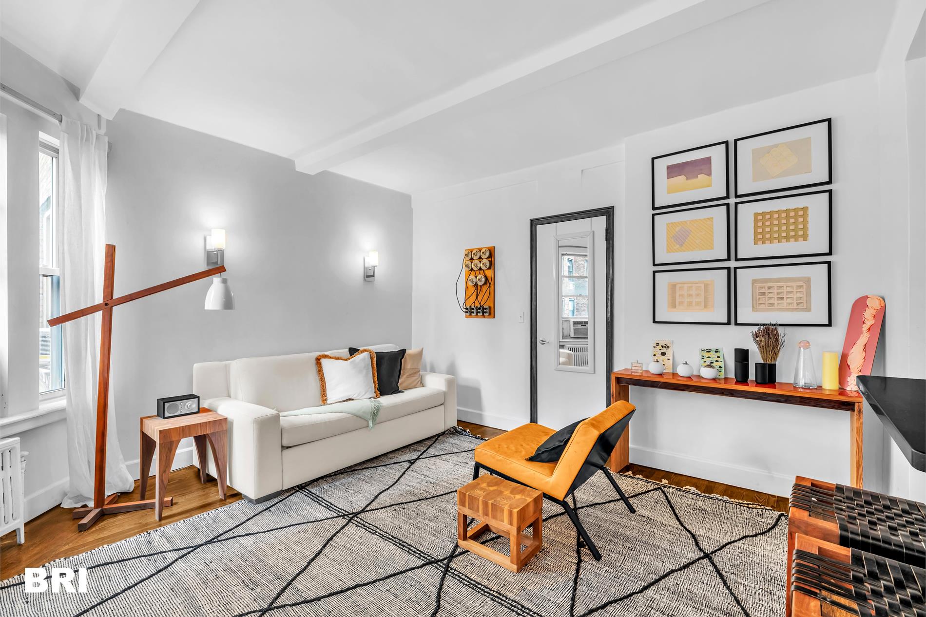 a living room with furniture a flat screen tv and a dining table