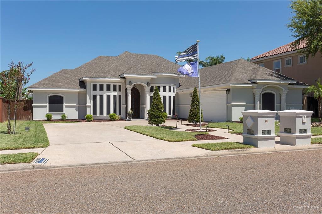 Stunning modern stucco exterior with elegant lines and inviting curb appeal. Welcome to your dream home with lots of parking and a pretty yard.   Well maintained with sunscreens on the windows and a grand entry!