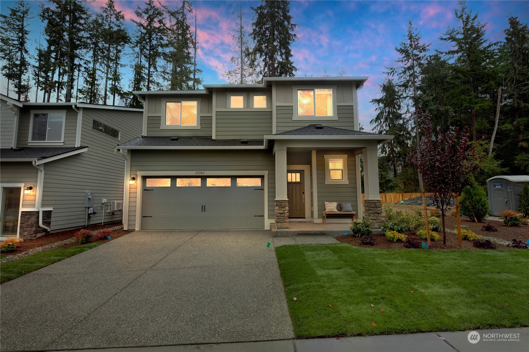 a front view of a house with a yard and outdoor seating