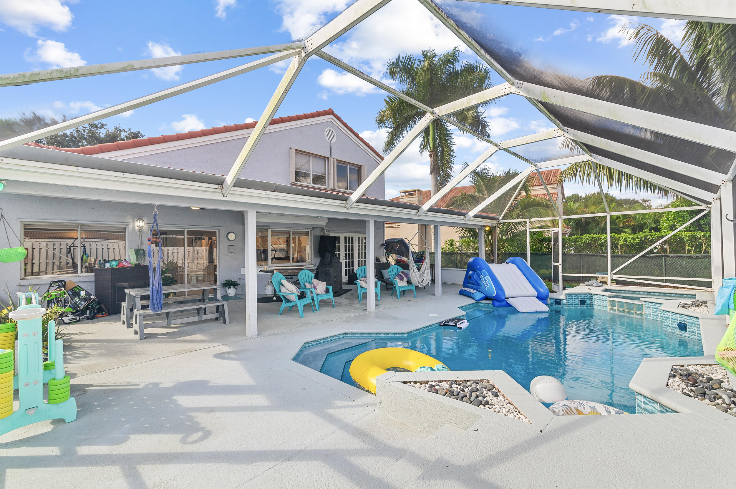 a view of a swimming pool with outdoor seating