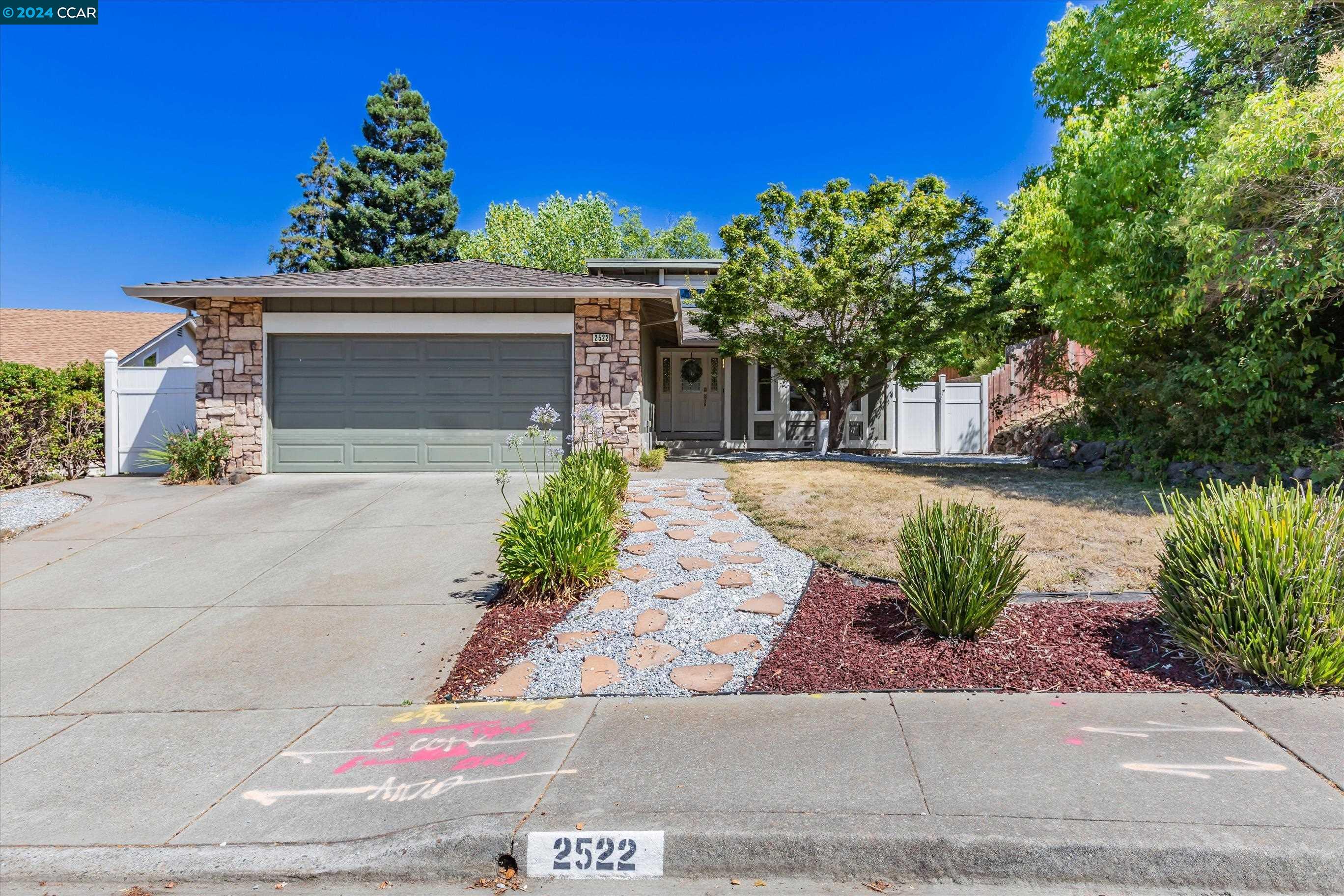 a front view of a house with a yard and a garage