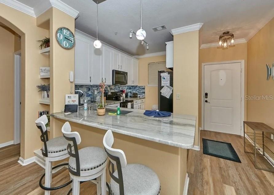 a dining table with chairs and chandelier