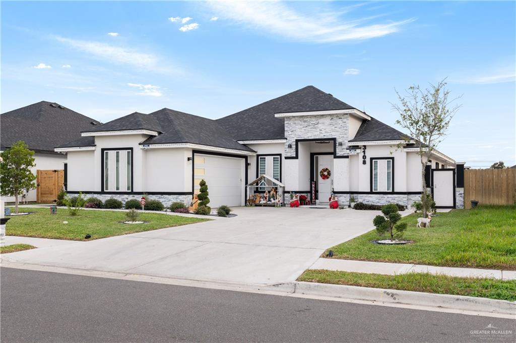 a front view of a house with a yard and garage