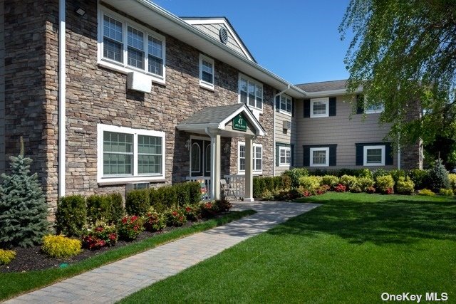 a front view of a house with a yard and porch