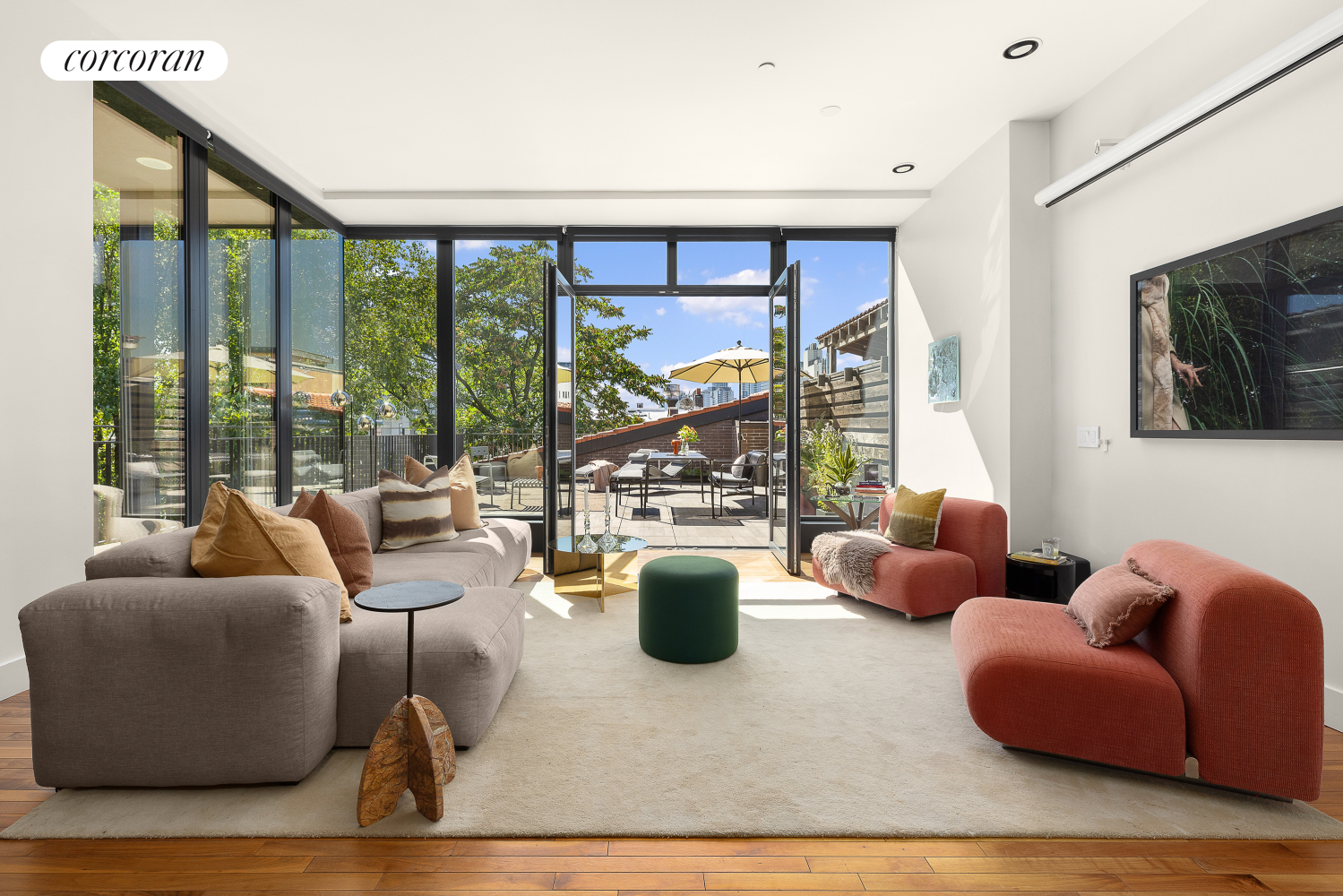 a living room with furniture and a floor to ceiling window